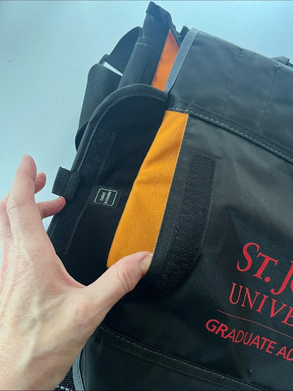 UNISEX St. John’s University Black Messenger Bag with Red Logo